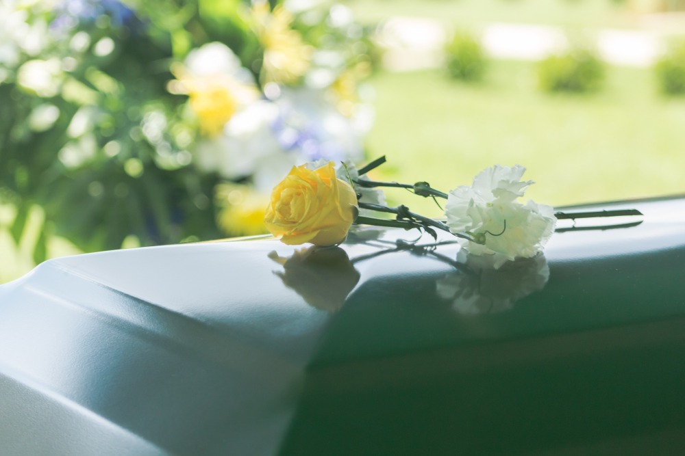 flowers on a coffin - Houston, TX | Domingo Garcia Law Firm